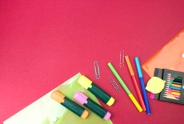 Back to school. Stationery on a Burgundy table. Office desk with copy space. Flat lay