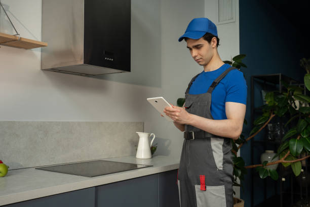istock Professional Technician Using Tablet to Schedule Repair Services in Modern Kitchen 2151881891