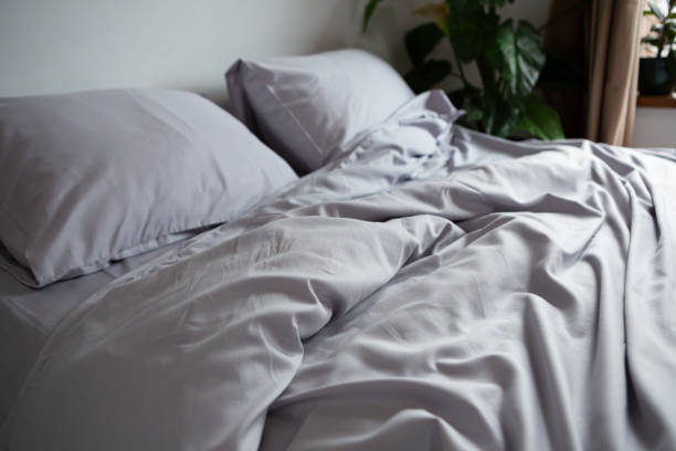 istock morning mess on the bed, light bedding, pillowcase and blanket 2151883790