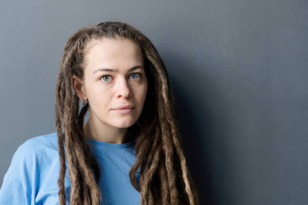 istock Woman with Long Dreadlocks Standing on Grey 2151883934