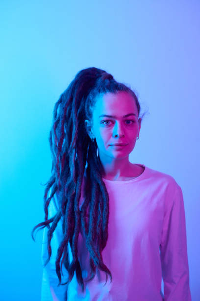 istock Caucasian young woman with dreadlocks in blue neon 2151883985