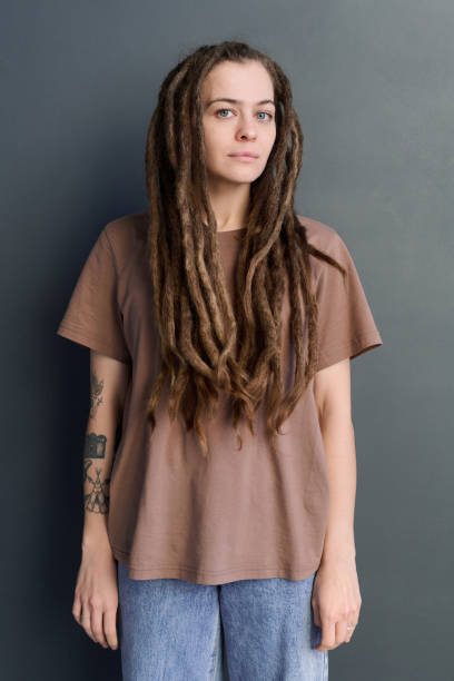 istock Caucasian woman with long dreadlocks standing on grey 2151883996