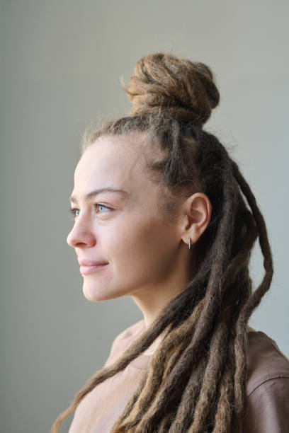 istock Profile view of woman with long dreadlocks 2151883997
