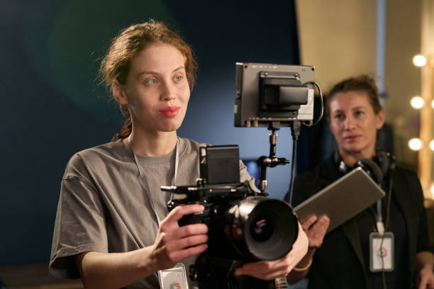 istock Smiling Woman Operating Professional Camera Equipment 2151886098