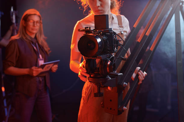 istock Woman Operating Video Camera in Neon Lights 2151886120