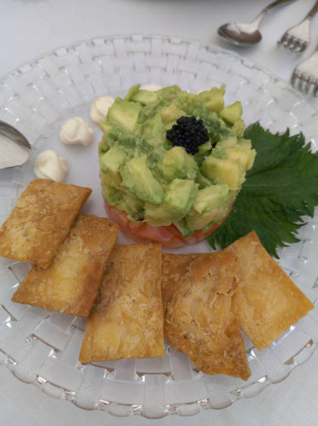 istock Avocado timbale with salmon decorated on a glass plate. 2151890411