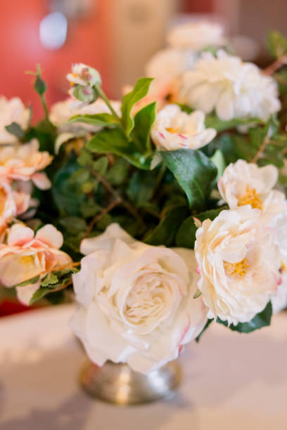 istock A beautiful bouquet of roses and greenery sitting on a white table. 2151897073