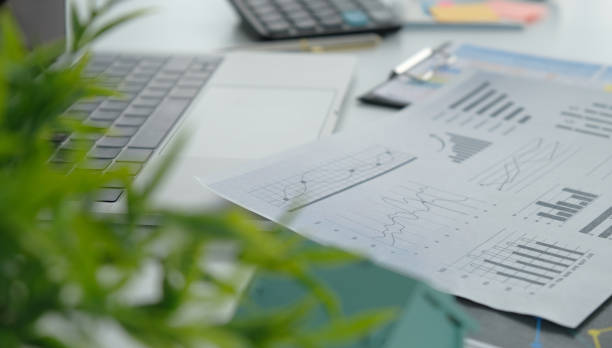 istock a white office desk with business financial cards, documents, a calculator, a laptop computer and supplies. a place to copy. 2151898782