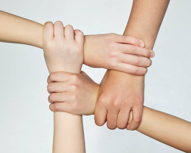 istock Group of children's hands holding on to each other, symbolizing work in team and unity isolated grey background. 2151899200
