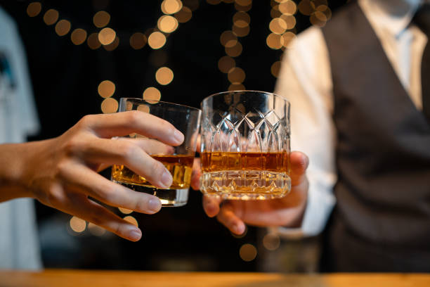 istock Barman pouring whiskey whiskey glass beautiful night 2151899255
