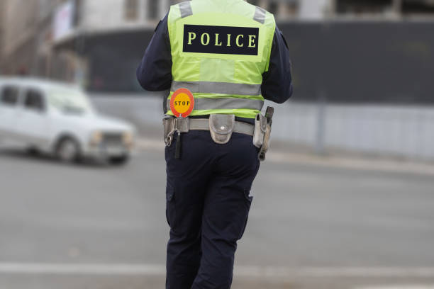 istock police officer's behind while organizing traffic 2151899980