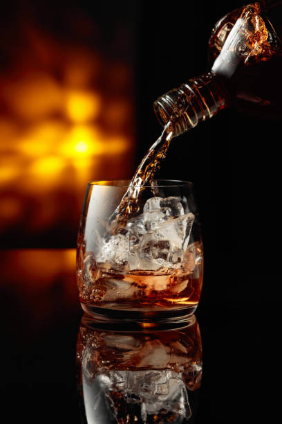 istock Pouring whiskey into a glass with ice. 2151902419