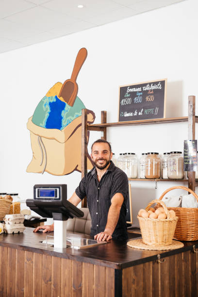 istock Smiling Storekeeper at Zero Waste Eco-Friendly Grocery Counter 2151903687