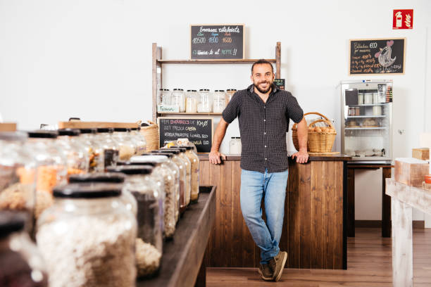 istock Smiling Man at Zero Waste Eco-Friendly Grocery Store Counter 2151903694