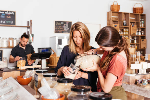 istock Mother and Daughter Selecting Bulk Rice at Eco-Friendly Grocery Store 2151904553