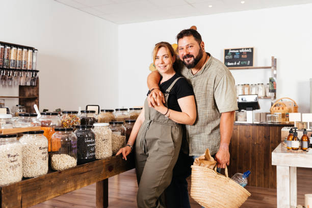 istock Couple Posing Together at Eco-Friendly Bulk Grocery Store With Wicker Basket 2151904681
