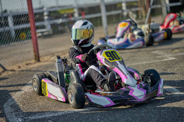 istock Girl driving go-cart ready in pit 2151905405
