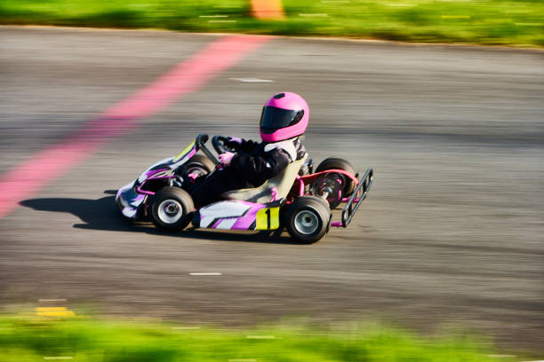 Child driving go-cart on racing track