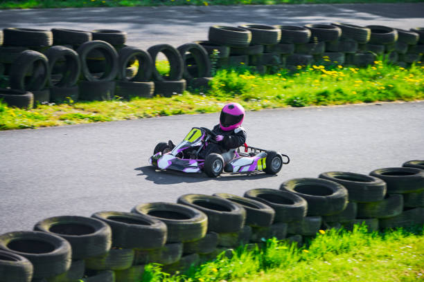 Child driving go-cart on racing track