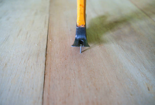 One hammer nailed stuck on a white background, studio shot.