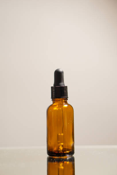 istock A bottle of an essential oil on a  reflective surface 2151909532