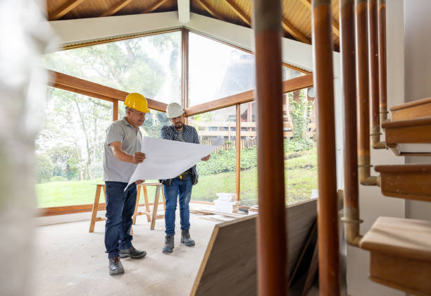 istock Architect and contractor renovating a house and looking at the blueprints 2151912566