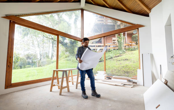 istock Architect renovating a house and looking at the blueprints 2151912568
