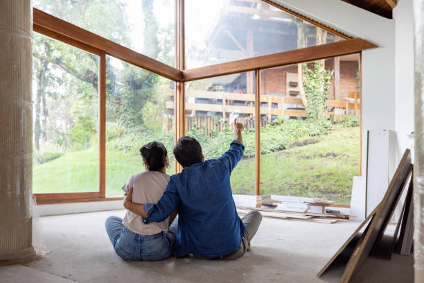Couple daydreaming while remodeling their house and sharing some ideas