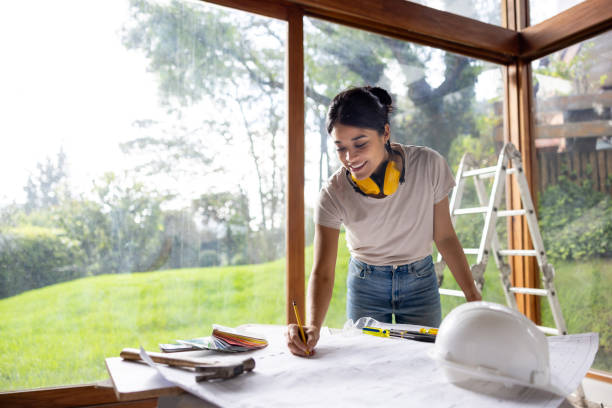 istock Architect renovating a house and drawing ideas on a blueprint 2151912593