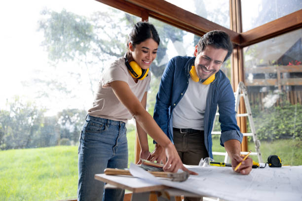 istock Couple remodeling their house and looking at the blueprints 2151912610