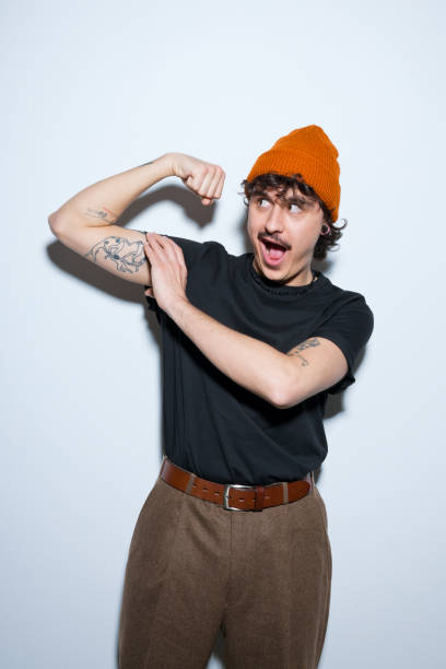 istock Portrait of excited young man flexing his bicep 2151914247