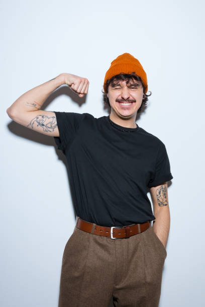 istock Portrait of smiling young man flexing his bicep 2151914327
