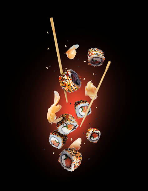 istock Delicious fresh sushi rolls with ginger in the air on a black background 2151914473
