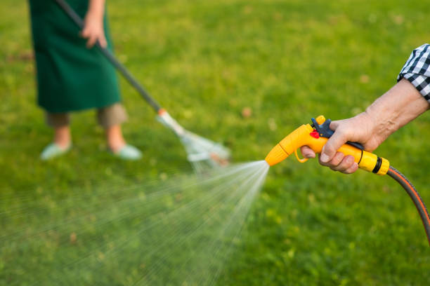 istock Old hand holding water hose. 2151916958