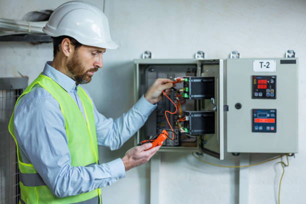 istock A male electrician works in a switchboard with an electrical connecting cable. 2151919087