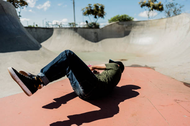istock Young skateboarder falling from skateboard at skate park 2151919227