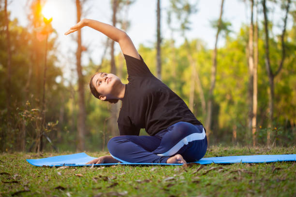 istock active women practicing stretching yoga sitting on a yoga mat 2151919284