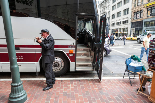 San Francisco, CA, USA - August 19, 2006: A bus driver is smoking a pipe next to the bus
