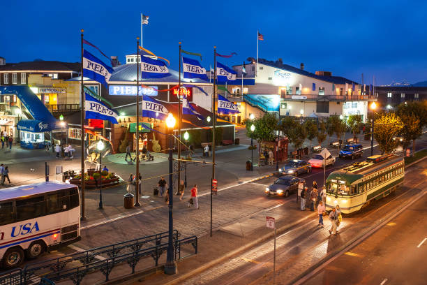 San Francisco, US - August 18, 2006: Visitors walk on Pier 39 stores and restaurants in evening at Fishermans wharf, San Franscisco