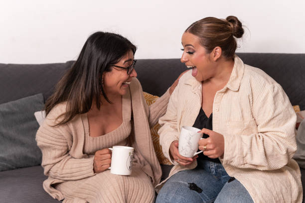 istock Friends having fun sharing conversation and coffee at home 2151920029