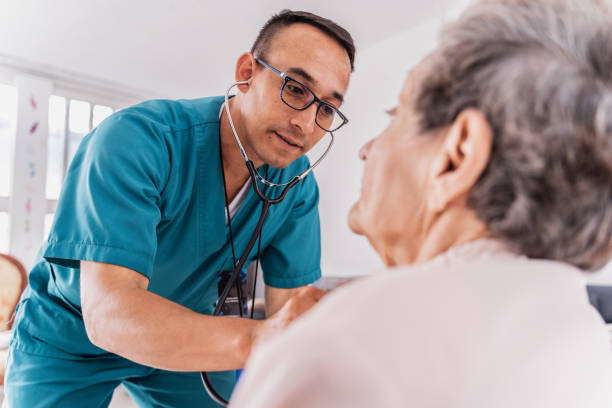 Nurse listening heartbeat of a senior woman during medical consultation Nurse listening heartbeat of a senior woman during medical consultation primary care stock pictures, royalty-free photos & images