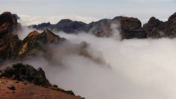 istock mist flowing over the incredible mountain in Madeira 2151922295