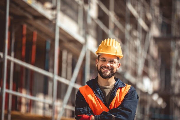 istock Construction site manager standing  wearing safety vest and helmet, thinking at construction site. 2151925176