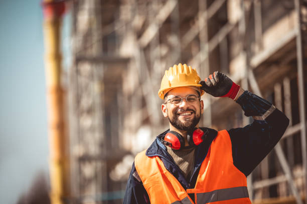 istock Construction site manager standing  wearing safety vest and helmet, thinking at construction site. 2151925183