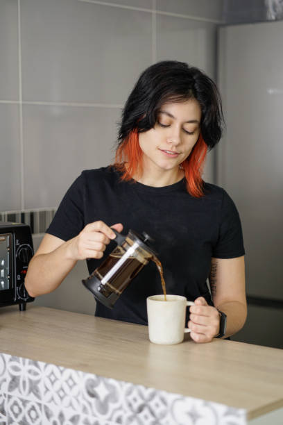 istock Person serving coffee from a french press to a mug 2151925358
