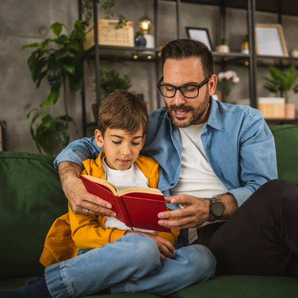 istock Father and son read a book and have fun while spend time together 2151926144
