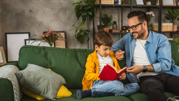 istock Father and son read a book and have fun while spend time together 2151926157