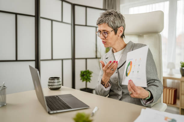 istock Mature woman share statistics have consultation via video call office 2151927794