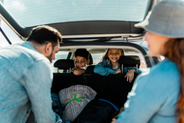 istock Family unloading luggages from the car trunk on the beach 2151927922