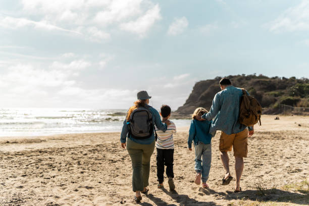 istock Family talking and walking through the beach 2151928420